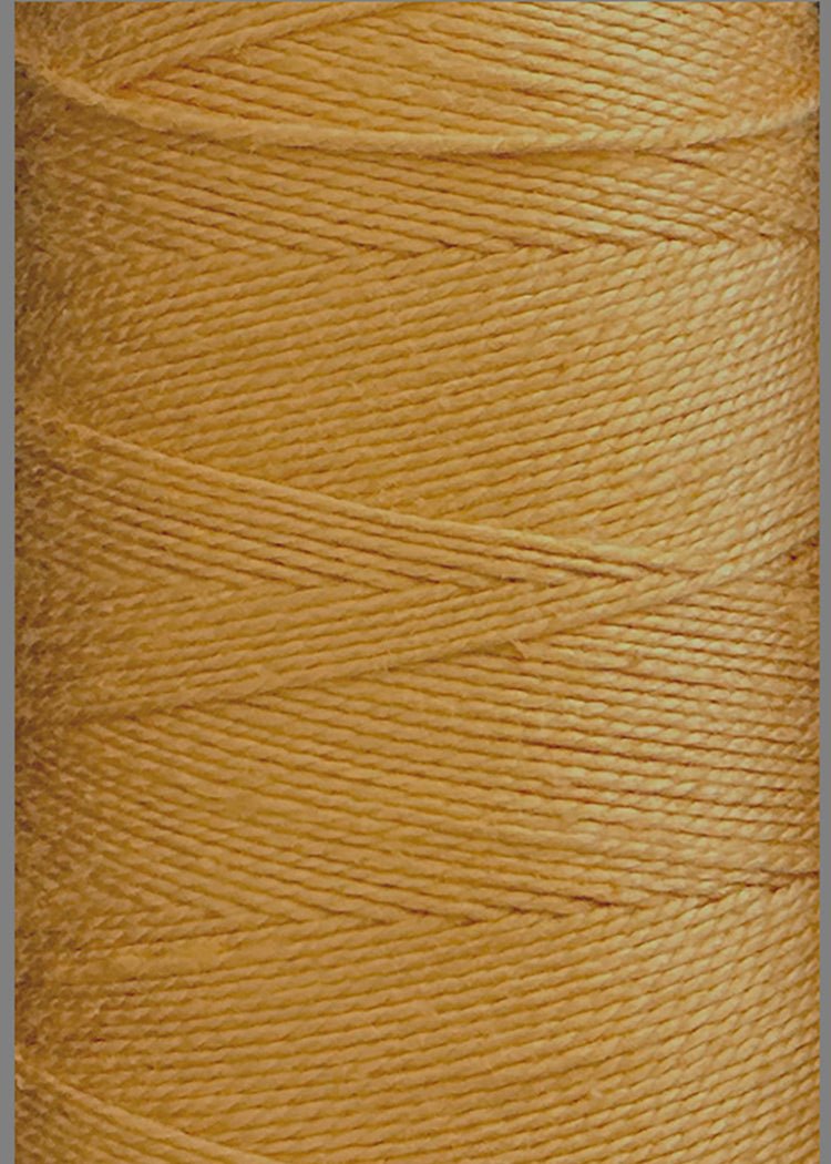 Close-up of a large cone of Circulo 10/2 Looma Circulo Mercerized Pearl Cotton Yarn in golden-yellow, highlighting the texture and detailed overlapping pattern of the tightly wound fibers.