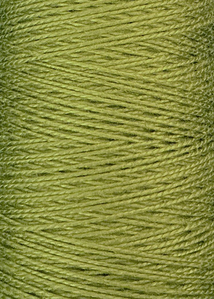 A close-up of a spool of Circulo's 3/2 Looma Mercerized Pearl Cotton Yarn in light green, highlighting the tightly wound, lustrous fibers arranged in a crisscross pattern reminiscent of weaving yarn or pearl cotton.