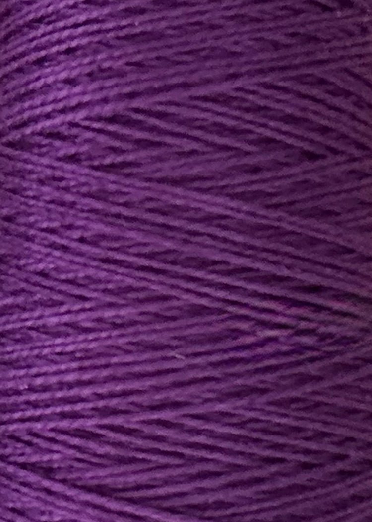 Close-up of purple 5/2 Looma Circulo Mercerized Pearl Cotton Yarn wound tightly on a mini cone, showing the texture and horizontal lines created by the layers of Oeko-Tex certified weaving yarn from Circulo.