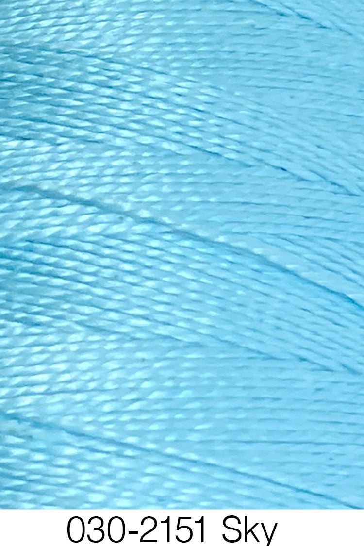 Close-up of shiny sky blue 5/2 Looma Circulo Mercerized Pearl Cotton Yarn, wound in parallel layers and crafted from Oeko-Tex certified cotton for quality and safety. The label below reads 030-2151 Sky by Circulo.