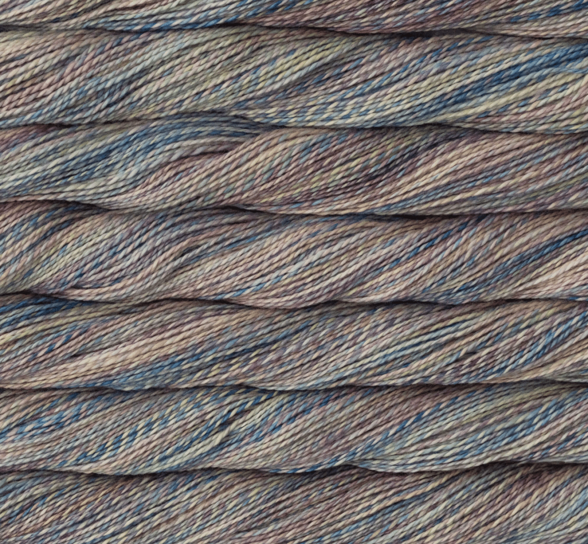 Close-up of Malabrigo Torzal sport weight yarn in variegated shades of blue, purple, and tan.