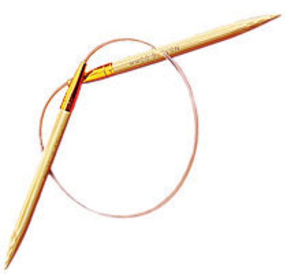 Two Circular Bamboo Knitting Needles by Accessories Unlimited (SeeKnit) are laid in a crisscross pattern on a white background, joined with a flexible transparent cable.