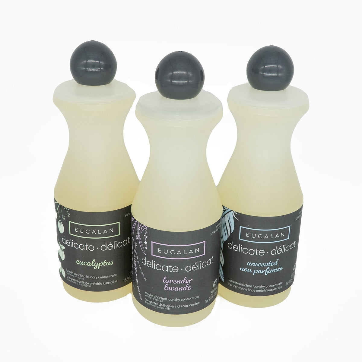 Three 16.9 oz (500 ml) bottles of Eucalan Wool Wash by Eucalan stand side by side on a white background, showcasing eucalyptus, lavender, and unscented varieties. This gentle no rinse formula is specially crafted for your most delicate laundry.