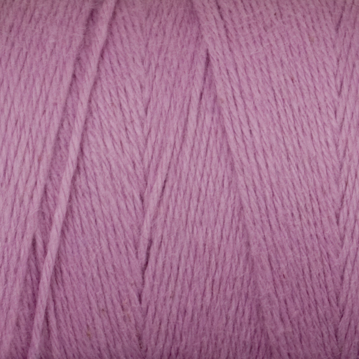 Close-up of Great Northern Weaving's Cotton Carpet Warp 8/4, featuring soft, lilac-colored 4-ply cotton yarn with visible texture and vertical strands.