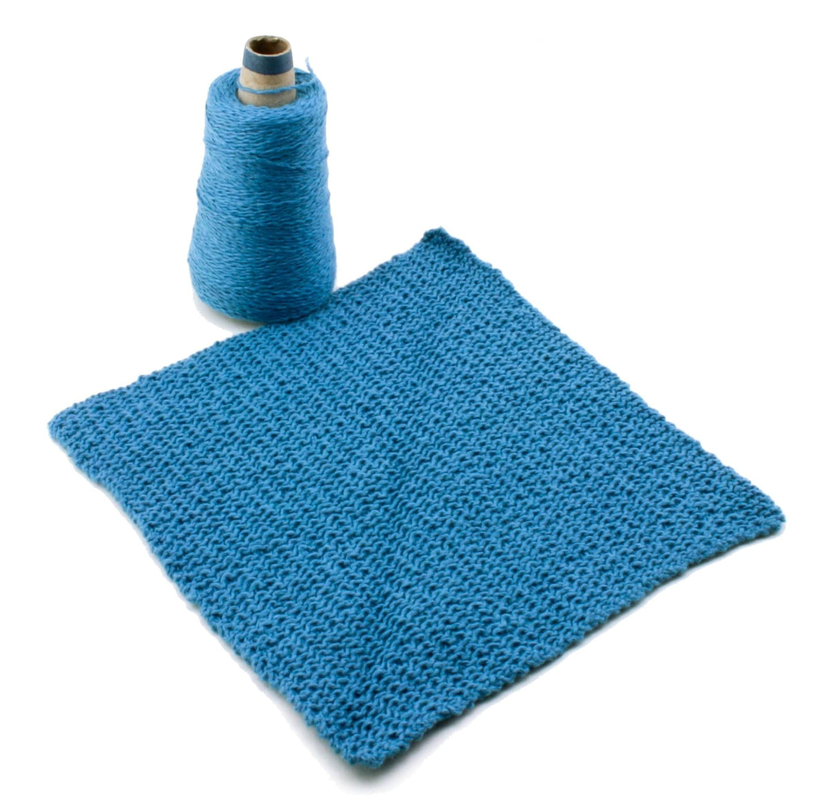 A blue sport weight cotton yarn spool and a knitted swatch, ideal for washcloths, are set against a white background. Featured: Casco Bay Washcloths (download) by Halcyon Yarn.