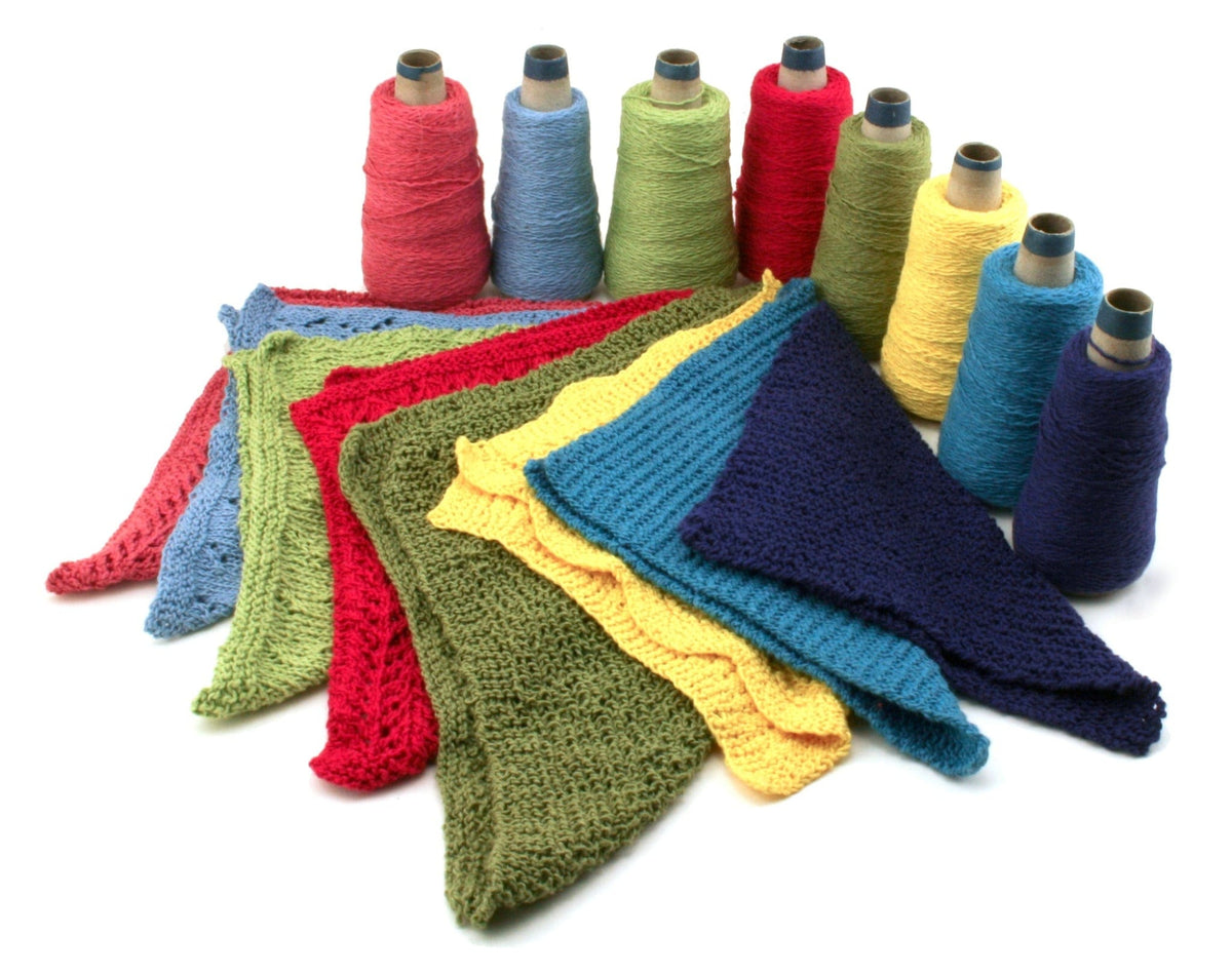 Halcyon Yarn Casco Bay Washcloths download features sport weight cotton yarn cones, with triangular washcloths in matching red, green, blue, and yellow tones displayed on a white background.