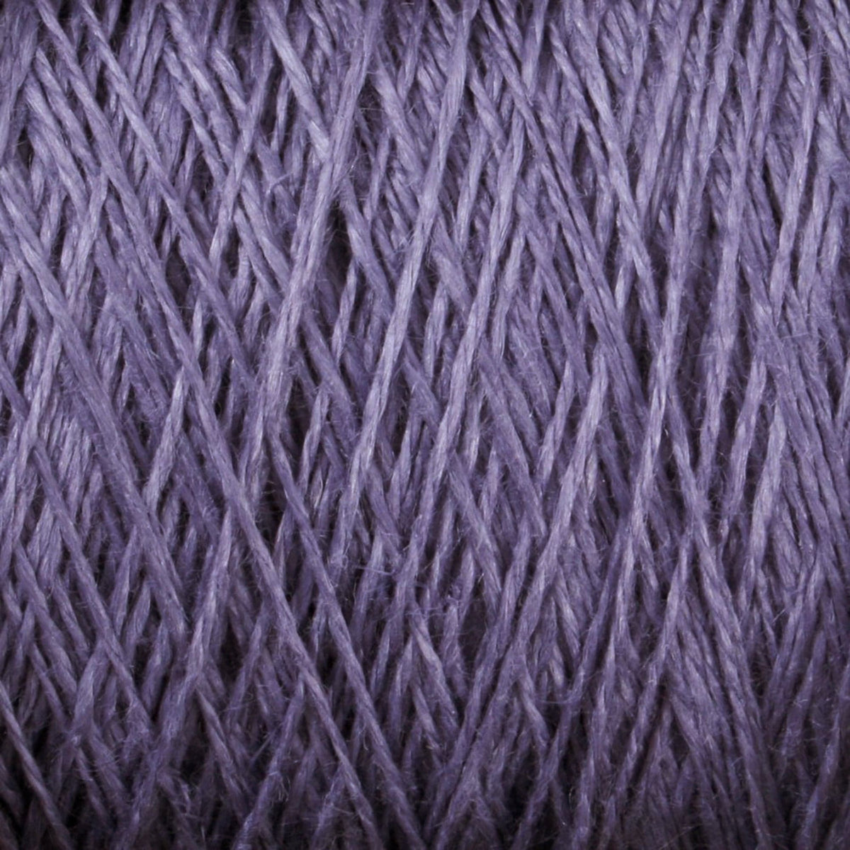 Close-up view of soft, purple Newport 16/2 Linen Yarn Mini-cone strands by Halcyon Yarn, overlapping and crisscrossing to highlight the texture and fibrous detail of the material.