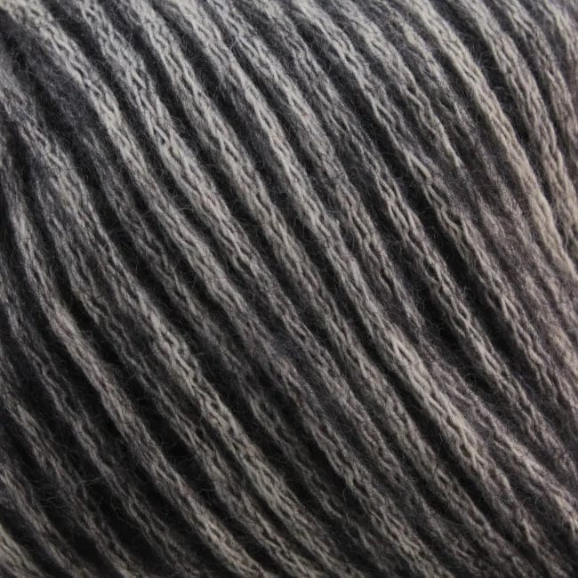 Close-up of a ball of Katia Cotton-Merino yarn by Katia, featuring its soft texture and twisted strands in dark and light gray tones, characteristic of super soft Merino fibers.