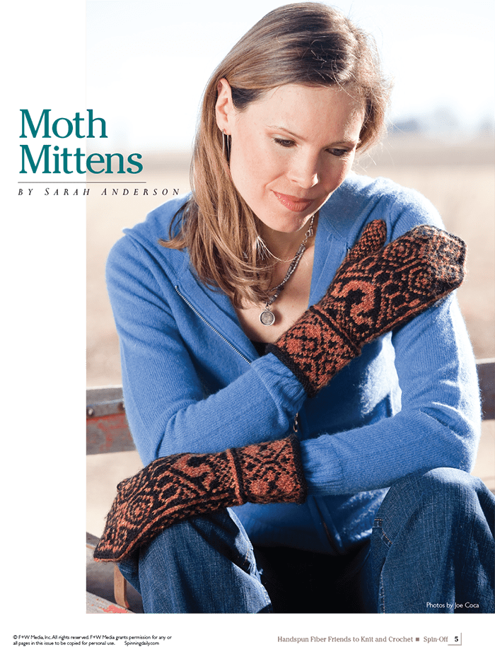 A woman in a blue zip-up hoodie and jeans sits outdoors, admiring her orange and black patterned mittens. Text reads: Spin-Off Presents: Handwoven, Fiber Friends to Knit and Crochet—by Long Thread Media.