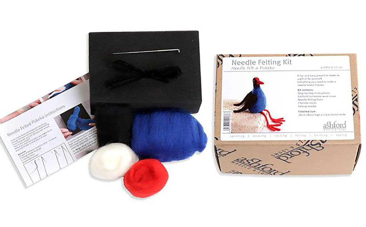 Ashford Needle Felting Kits by Ashford Handicrafts Limited include blue, white, and red wool, black foam block, two felting needles, instructions, and a box with a finished bird—ideal for beginners starting needle felting projects.