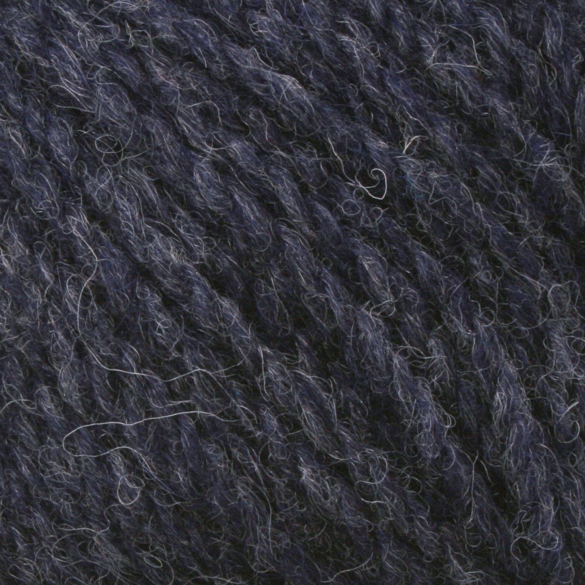 Close-up of Bartlettyarns Maine Wool Yarn (Fisherman 2-Ply) by Bartlettyarns in dark blue and gray, highlighting its soft, fuzzy texture and twisted fibers.