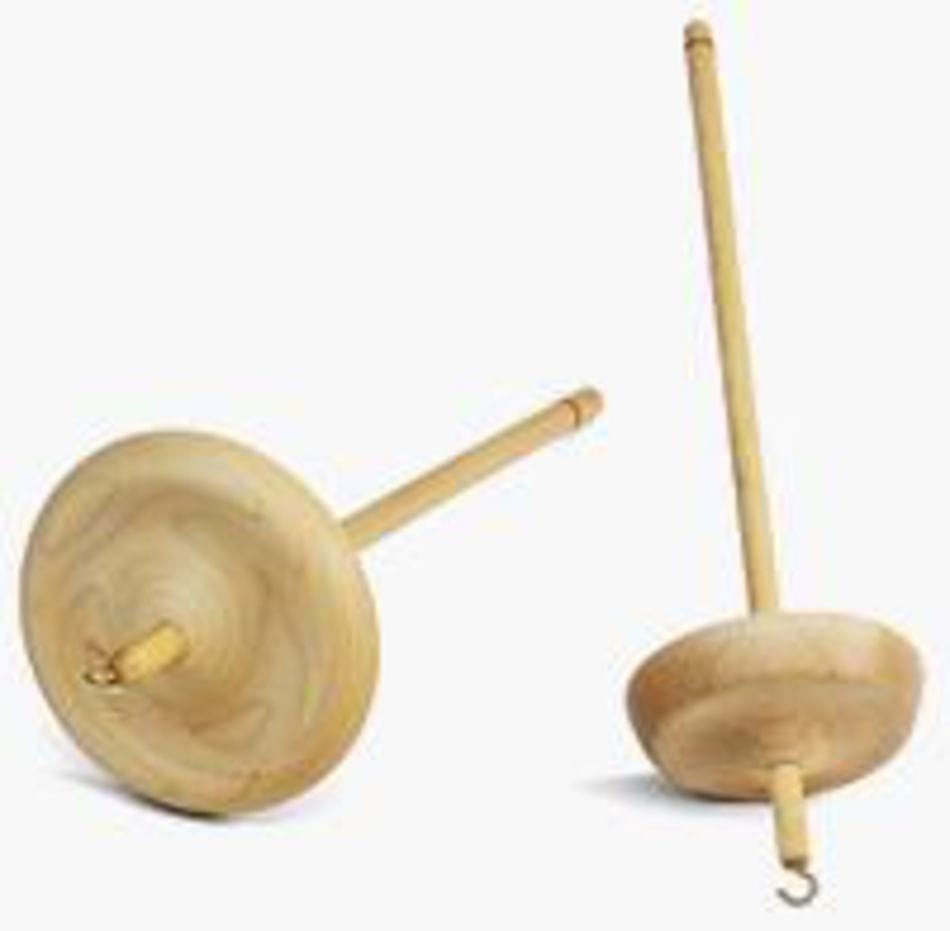 Two Schacht Hi-Lo Drop Spindles by Schacht Spindle Co.—one low-whorl and one high-whorl—rest on a light surface, both with metal hooks at the top for spinning fibers into yarn.