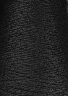 Close-up view of tightly wound Circulo 3/2 Looma Mercerized Pearl Cotton Yarn in black on a large cone, highlighting its textured and slightly shiny fibers.