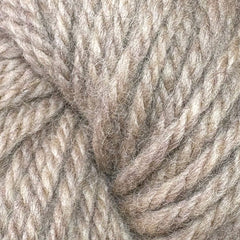 Close-up of Halcyon Yarn Classic Rug Wool | Skein from Caledonian Dye Works—thick, beige strands with soft, fibrous texture and subtle color variations; ideal for rug weaving or crafting with durable wool.