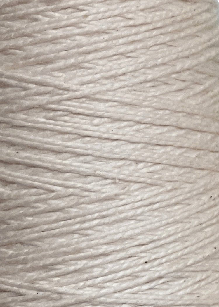 Close-up of a spool of Circulo 5/2 Looma Circulo Mercerized Pearl Cotton Yarn | Large Cone, tightly wound in a circular pattern with visible texture and subtle sheen—crafted from 100% mercerized cotton, this weaving yarn from Circulo delivers both durability and elegance.