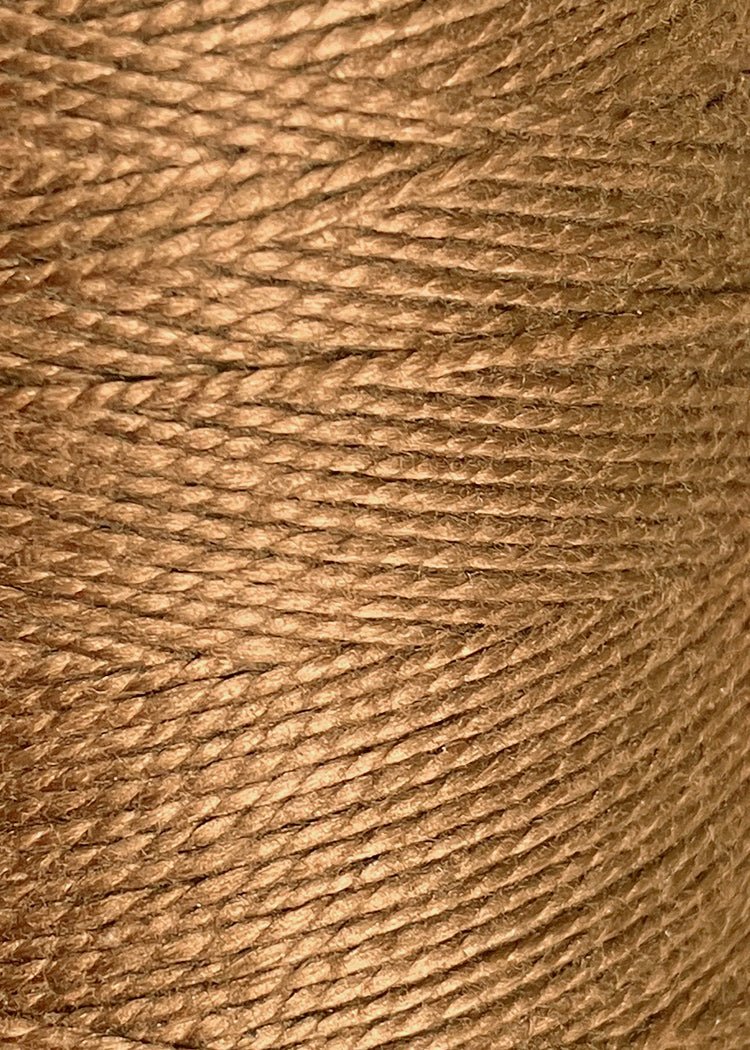Close-up of tightly wound 3/2 Looma Circulo Mercerized Pearl Cotton Yarn (Mini Cone) by Circulo, highlighting the detailed texture and fibers of the yarn—ideal for weaving and craft projects.