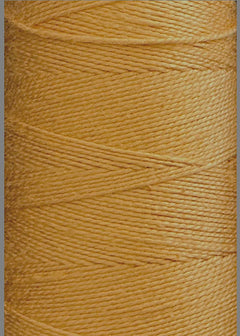 Close-up of a spool of Circulo 5/2 Looma Mercerized Pearl Cotton Yarn | Large Cone in golden yellow, tightly wound in neat, diagonal layers to highlight the fine texture and lustrous sheen of the mercerized pearl cotton fibers.