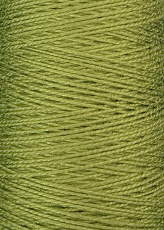 Close-up of a spool of Circulo 10/2 Looma Mercerized Pearl Cotton Yarn in light green, with the threads tightly wound in overlapping diagonal layers on a large cone.