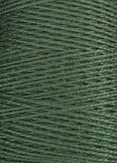 Close-up of tightly wound green 5/2 Looma Circulo Mercerized Pearl Cotton Yarn on a large cone, showcasing its smooth texture and distinctive diagonal overlapping lines. This Circulo weaving yarn is Oeko-Tex certified, emphasizing both quality and sustainability.