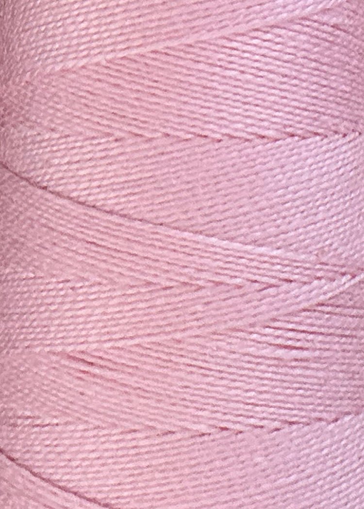 Close-up view of light pink Circulo 10/2 Looma Mercerized Pearl Cotton Yarn neatly wound around a large cone, highlighting the fine texture and parallel lines of its 100% cotton fibers. This Oeko-Tex certified pearl cotton from Circulo ensures both quality and safety in every detail.