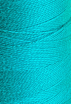 Close-up of a large cone of vibrant turquoise 5/2 Looma Circulo Mercerized Pearl Cotton Yarn by Circulo, highlighting the detailed texture and tightly wound fine strands—perfect for weaving yarn projects.