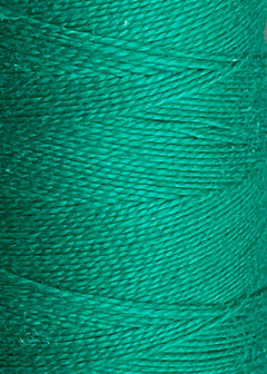 Close-up of the vivid green Circulo 5/2 Looma Mercerized Pearl Cotton Yarn wound snugly around a large cone, highlighting the detailed texture and individual strands of this premium weaving fiber.
