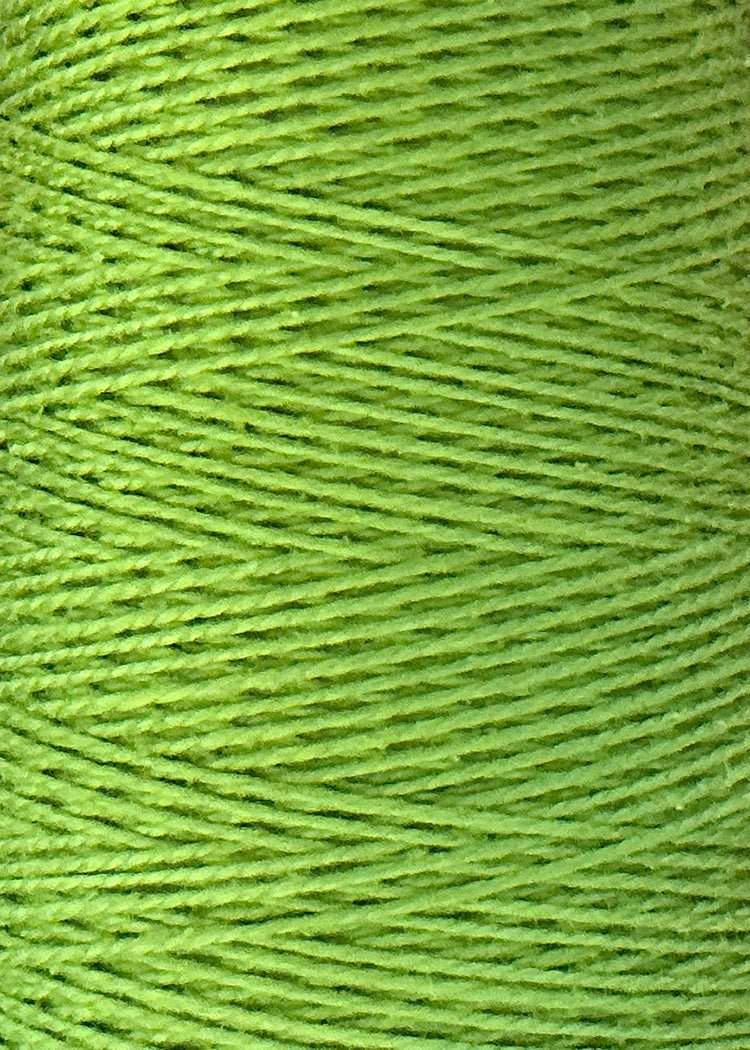 Close-up view of Circulo 5/2 Looma Mercerized Pearl Cotton Yarn in green, wound tightly in parallel rows on a large cone, highlighting the texture and fine fibers of the yarn.