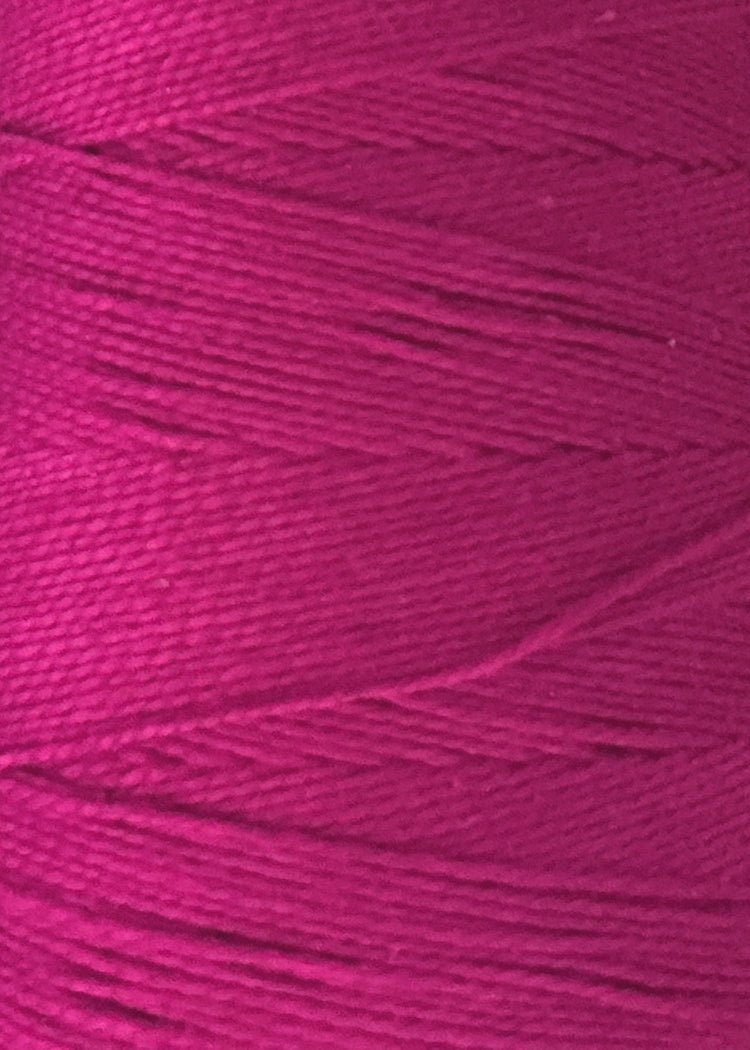 Close-up of a spool of magenta Circulo 5/2 Looma Mercerized Pearl Cotton Yarn | Large Cone, highlighting the fine texture and tightly wound Oeko-Tex certified fibers.