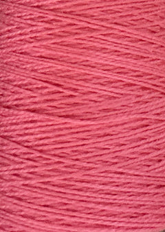 Close-up of a spool of Circulo 10/2 Looma Mercerized Pearl Cotton Yarn in pink, highlighting the texture and strands tightly wound in parallel layers on the large cone.
