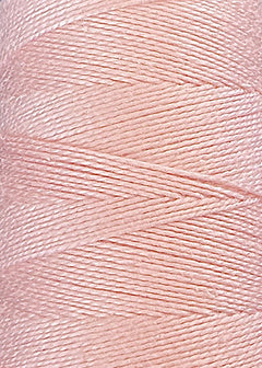Close-up of a spool of Circulo 10/2 Looma Circulo Mercerized Pearl Cotton Yarn in pale pink, showing tightly wound, shiny, and smooth fibers arranged in a neat diagonal pattern on the large cone.