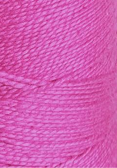 Close-up of a spool of Circulo 10/2 Looma Mercerized Pearl Cotton Yarn on a large cone, showcasing its vibrant pink hue and finely detailed, tightly wound fibers—perfect for weaving vivid textile projects.