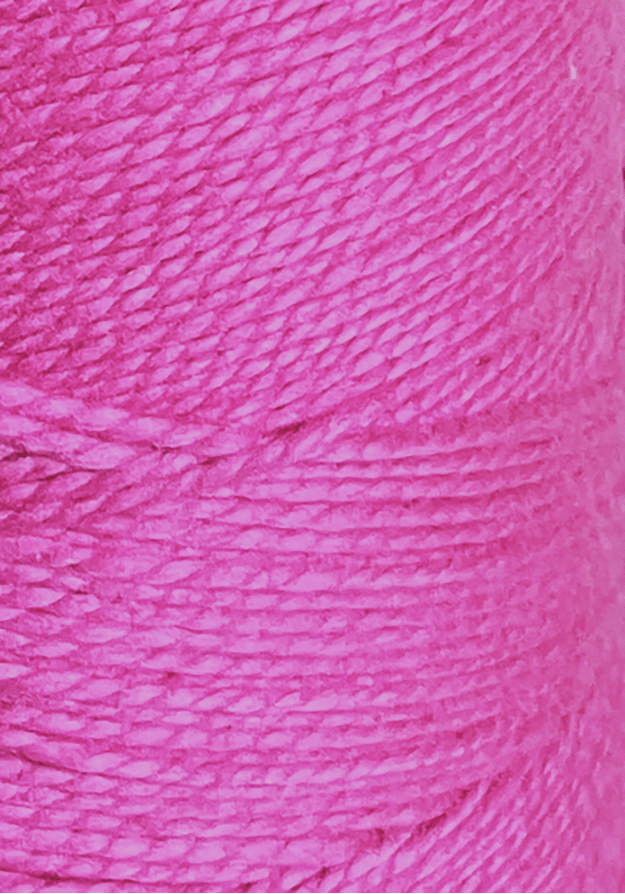 Close-up of vibrant pink 3/2 Looma Circulo Mercerized Pearl Cotton Yarn by Circulo, wound tightly in thick layers on a large cone to showcase the texture and fine fibers of the thread.