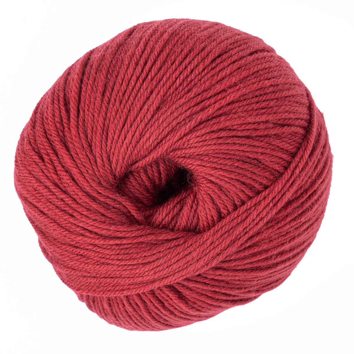 A close-up of Cascade 220 Superwash Wool Yarn by Cascade Yarns shows a vibrant red DK weight yarn ball, neatly wound in a circular shape with visible strands and a small center hole.