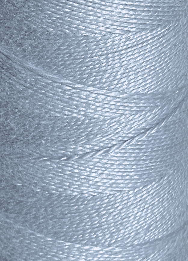 Close-up of a spool of Circulo 10/2 Looma Mercerized Pearl Cotton Yarn | Mini Cone in light blue, highlighting the smooth texture and tightly wound fibers.