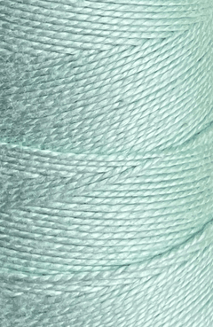 Close-up of tightly wound, pale blue Circulo 5/2 Looma Circulo Mercerized Pearl Cotton Yarn on a large cone, highlighting the texture and fine details of the mercerized fibers.