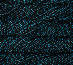 Close-up of Malabrigo Caracol super bulky, kettle-dyed merino wool yarn, featuring loosely plied, alternating black and bright blue strands.