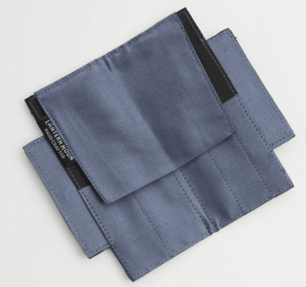 Two blue Lantern Moon Mindy Sleeve pouches by Bryson Distributing, Inc. with black trim overlap on a white background. Visible stitching and seams show quality craftsmanship, and one pouch features a small side label—ideal for needle storage.