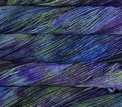 Three skeins of Malabrigo Merino Worsted Wool Yarn in a kettle-dyed, variegated pattern of deep purple, teal, and lime green.