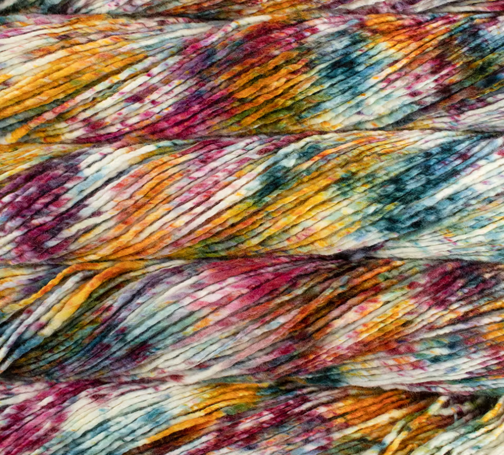 Skeins of Malabrigo Merino Worsted Wool Yarn in a kettle-dyed, variegated pattern of yellow, magenta, and teal against a cream background.