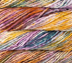 Close-up of thick, multicolored Malabrigo Rasta yarn in variegated shades of purple, orange, yellow, and blue.