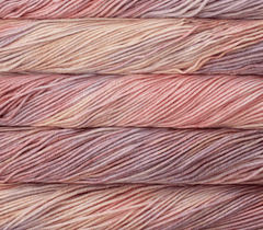 Four hanks of kettle-dyed Malabrigo Rios yarn in blended shades of pink, peach, and muted purple.