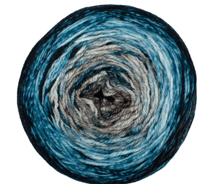 A circular cake of Malabrigo Sock yarn featuring a gradient transition from dark navy at the edges to lighter shades of blue, grey, and brown in the center.