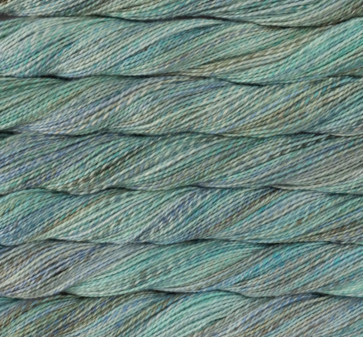 Close-up view of twisted teal and grey variegated sport weight Merino wool Malabrigo Torzal yarn.