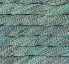 Close-up view of twisted teal and grey variegated sport weight Merino wool Malabrigo Torzal yarn.