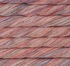 Close-up of a twisted skein of Malabrigo Torzal hand-dyed sport weight yarn in variegated shades of pink, peach, and soft purple.