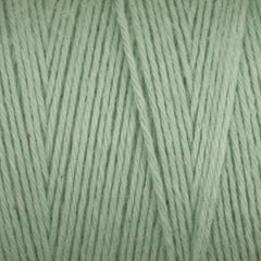 Close-up view of light green Great Northern Weaving Cotton Carpet Warp 8/4, highlighting the texture and tightly wound individual 4-ply cotton strands.