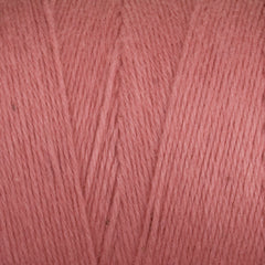 Close-up of Great Northern Weaving's Cotton Carpet Warp 8/4 in pink, showing the textured 4-ply cotton strands and diagonal winding—perfect warp yarn for rug making.