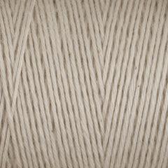 Close-up of Great Northern Weaving Cotton Carpet Warp 8/4: tightly wound beige 4-ply cotton yarn in parallel rows, highlighting its soft texture and durable, colorfast fibers.
