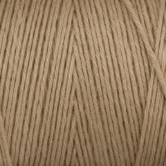 Close-up of Great Northern Weaving's Cotton Carpet Warp 8/4 in beige, featuring tightly wound 4-ply cotton strands and textured fibers—perfect for creating durable, colorfast rugs.
