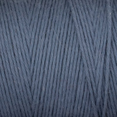 Close-up of blue-grey Great Northern Weaving Cotton Carpet Warp 8/4 yarn, highlighting the tightly twisted 4-ply cotton strands. This colorfast, soft, and smooth yarn is perfect for weaving or rug making projects.